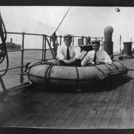 Two officers demonstrate a life raft