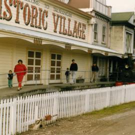Historic Village locomotive alongside buildings c. late-1990s