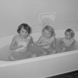 Three children in a bath