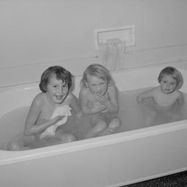 Three children in a bath