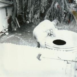 Neil Holmes cleaning out tanks, 1964