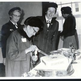 Mary Christian cutting Girl Guides' 50th cake, 1973
