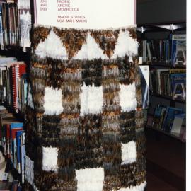 Kākahu covering a tukutuku panel waiting to be unveiled