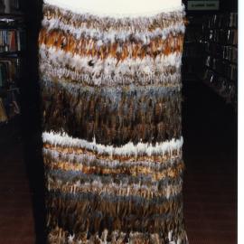 Kākahu covering a tukutuku panel waiting to be unveiled