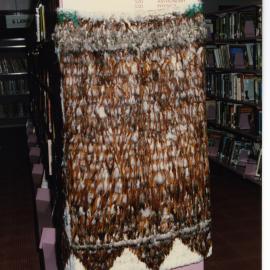 Kākahu covering a tukutuku panel waiting to be unveiled