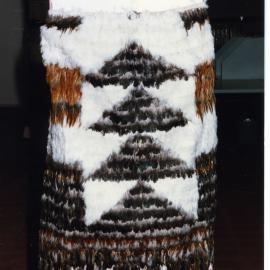Kākahu covering a tukutuku panel waiting to be unveiled