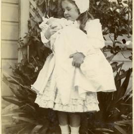 Young girl holding a baby