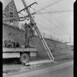 Linesmen repairing power pole