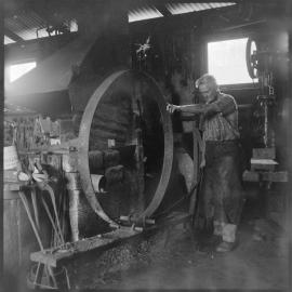Tauranga blacksmith Mr Charlie Haua works on steel "tyre" for wagon wheel in his Grey Street smithy