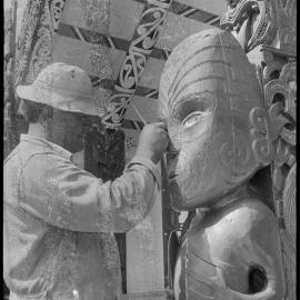 Mr Brown Rewiti restoring a carved figure at the Hairini Pā meeting house  