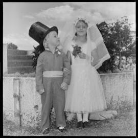 Young girl and boy dressed as bride and groom