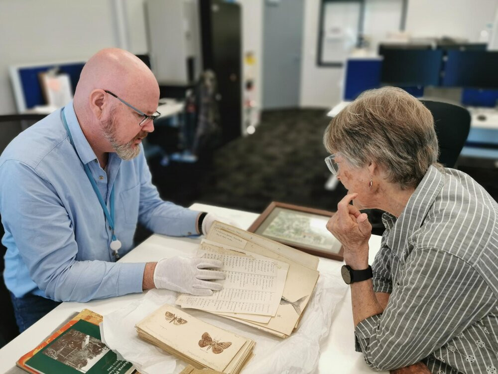 Pam Knox, grand daughter of Arnold Henfrey Watson, with Harley Couper, Heritage Specialist at Te Ao Mārama - Tauranga City Libraries.