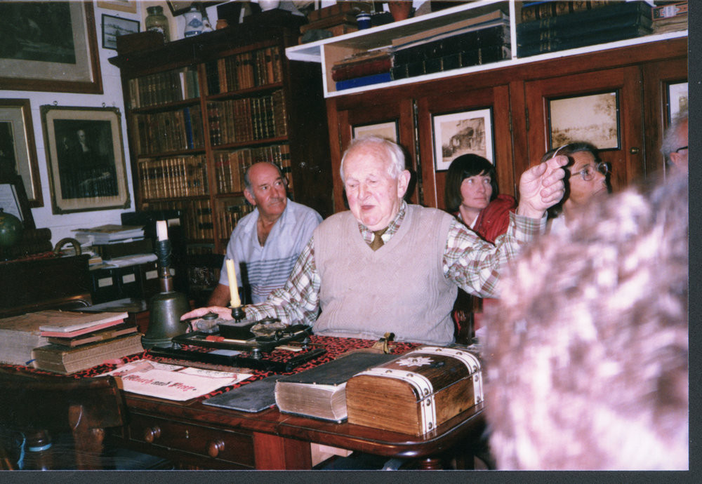 The Elms library, 1987: Duff Maxwell (in beige pullover) talking to the visiting Te Puke Genealogy Group from the Library's desk.  Photo 07-183

