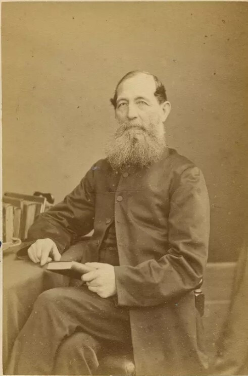 Portrait of Reverend Thomas Samuel Grace, seated and holding book. Auckland Museum PH-1969-33-4