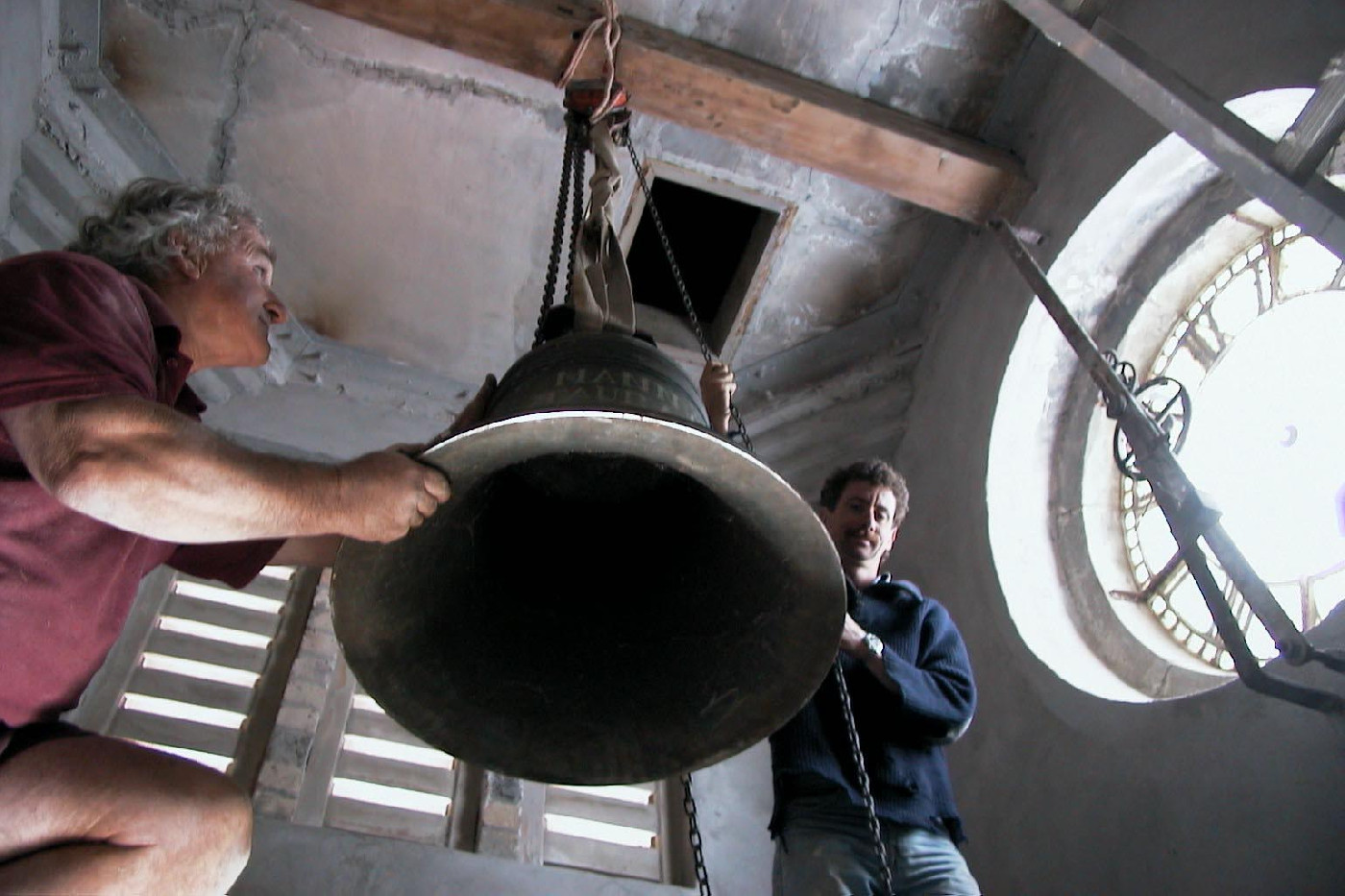The bell behind the clock face is manoeuvred into position during the 1999 restoration.

Photo NZME-CD014-199909-E2717-99