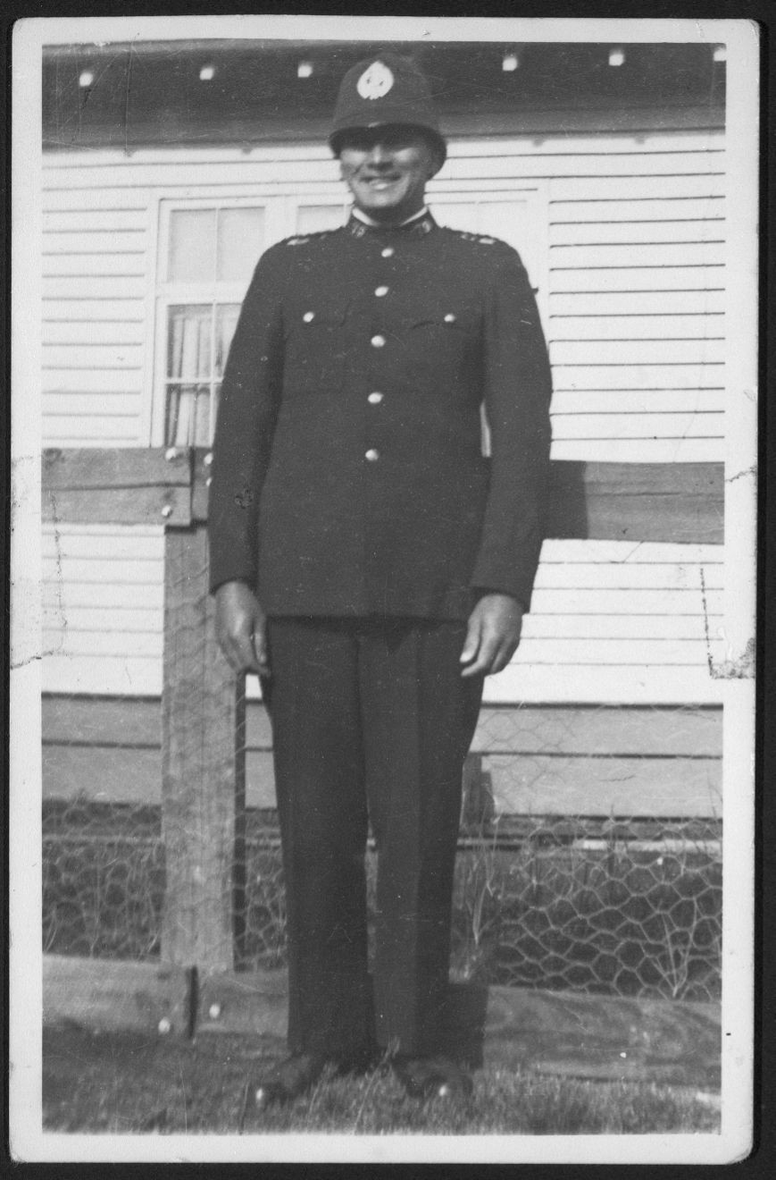 Photograph of Louis Hekenui Bidois (1899-1955), policeman, possibly in front of Te Whaiti Police Station, taken ca late 1930s by an unknown photographer" Alexander Turnbull Library reference 1/2-201351-F