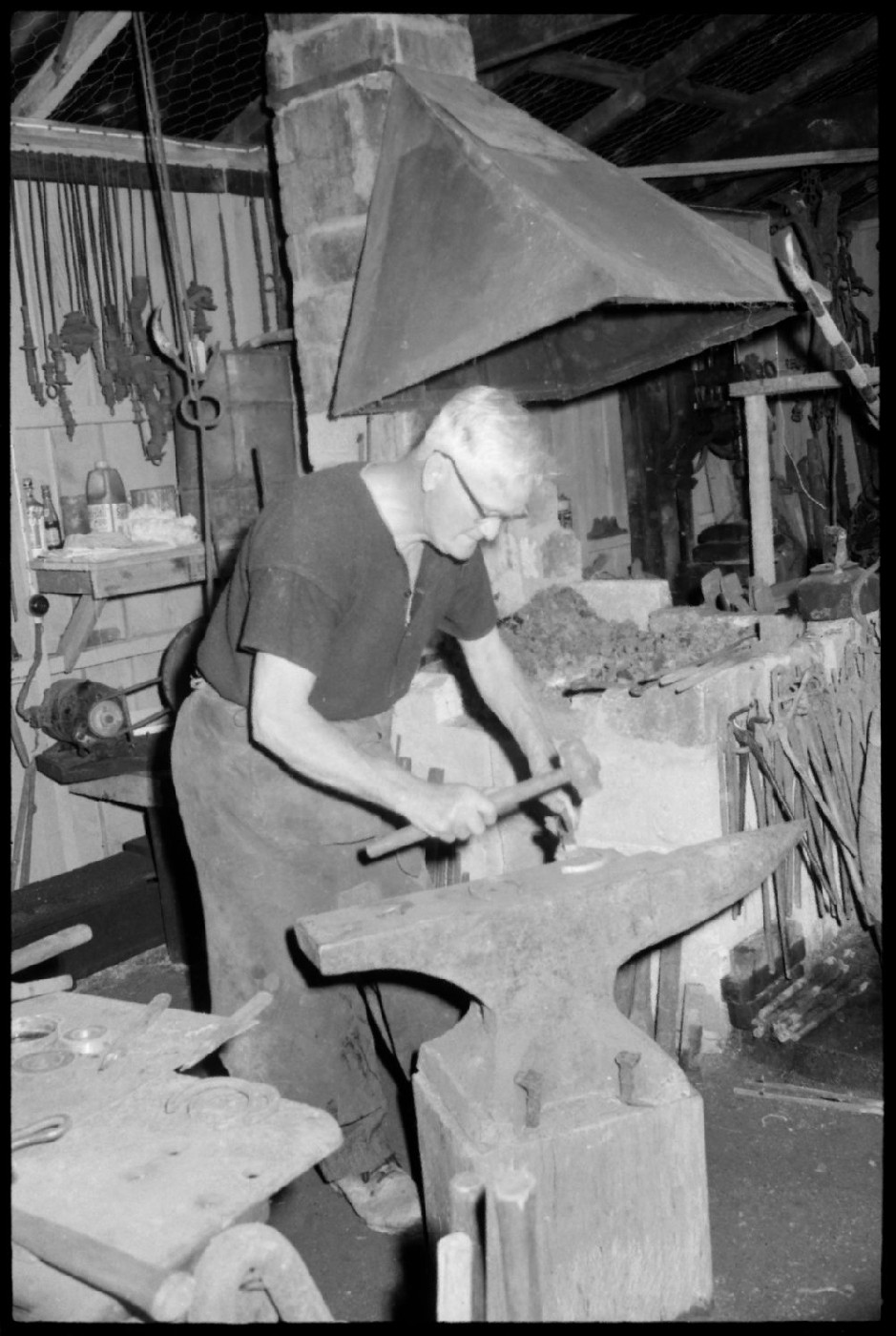 Charlie Haua with the old forge. From image Pn-8636