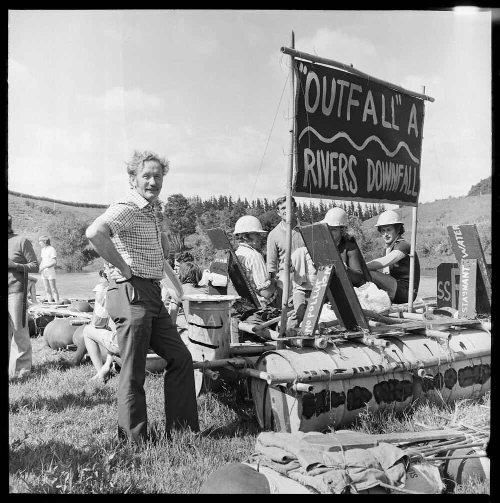 Bay of Plenty Young Farmers raft race at Kaituna River. MP for Bay of Plenty Mr MacIntyre inspects E. McDowell's 'best decorated' craft. Tauranga City Libraries Photo gca-22469